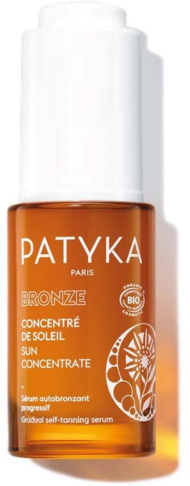 En liten orange flaska med vit öppning. Den har varumärket "PATYKA" och ordet "BRONZE" på sig.