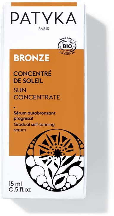 En förpackning av Patyka Solkonsentrat med orange och vit förpackning, har en svartvit blommönster.
