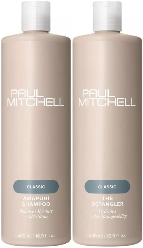 Two beige bottles of Paul Mitchell shampoo and conditioner, labeled "Classic" and "Awapuhi Shampoo" and "The Detangler."