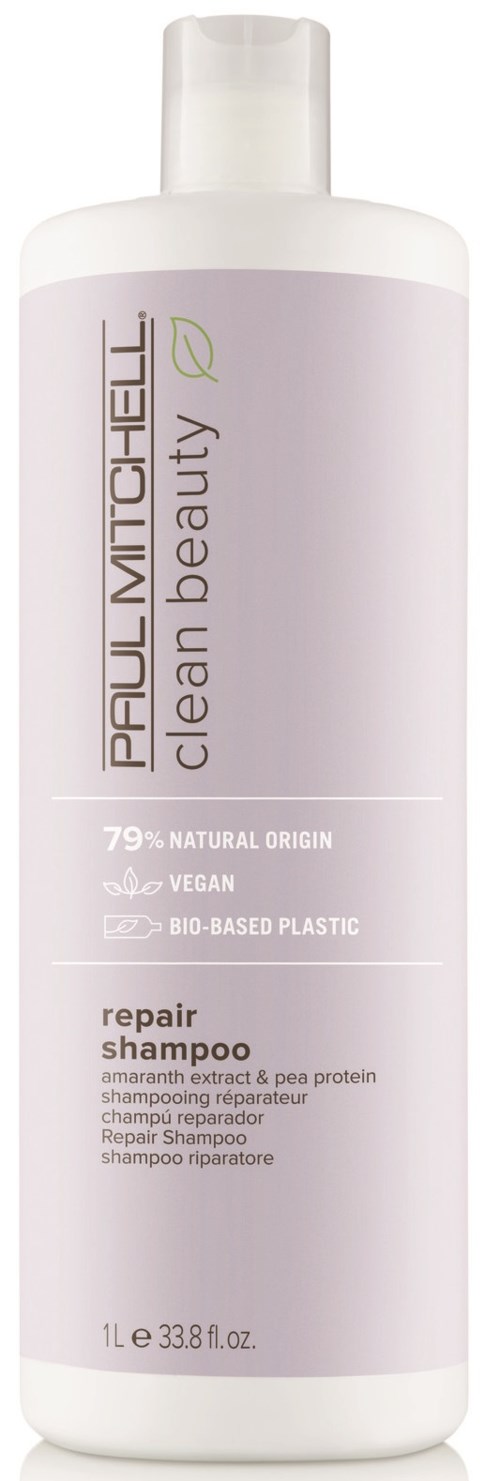 A tall, white bottle of repair shampoo by Paul Mitchell, labeled for vegan and natural ingredients.