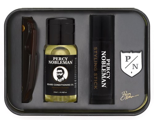 Raknings kit med trimmer, skäggolja och stylografisk penna, organiserade i ett metallfodral.