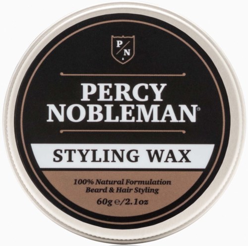 Een ronde container Percy Nobleman stylingwax in zwart, wit en roze, gebruikt voor haar- en baardstyling.