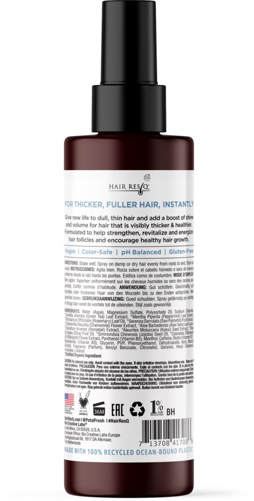 Eine Flasche Hair Rescue Serum mit Sprühaufsatz, dunkle Farbe und detailliertem Etikett.