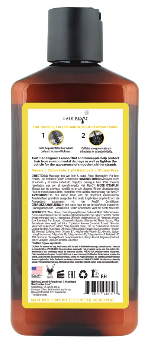 Eine braune Flasche mit schwarzem Deckel, gelbes und weißes Etikett, enthält Haarpflegeprodukt.