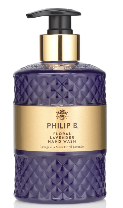 En lila, texturerad flaska med svart pump, guldkant och etikett som säger Philip B. floral lavendel handtvätt.