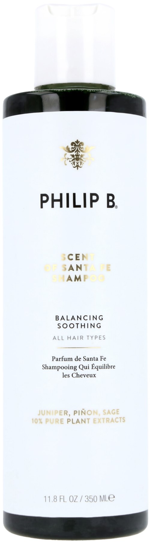 En vit och svart flaska med Philip B. schampo med guldbladsliknande logo, märkt 'Balancing Soothing' för alla hårtyper.
