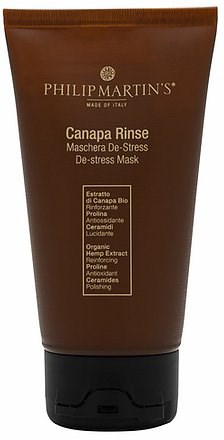 En brun tube med Philip Martins ansiktsmaske med gulltekst og svart bunn, merket Canapa Rinse, De-stress.