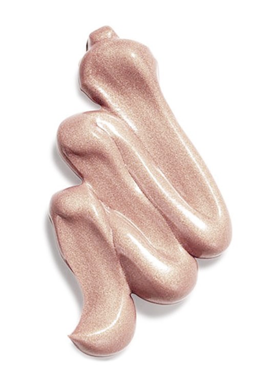 Ett glansigt, beige sminkprodukt, troligen concealer eller highlighter, formad i ett böjt, förlängt format.
