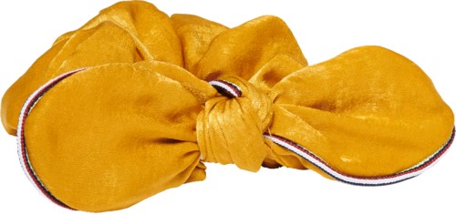 En stor gul tygscrunchie med en knut i mitten och en rad små ränder längs kanten.