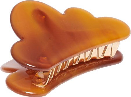 En hårklämma som ser ut som ett leende krokodiler med en glänsande, brun- och orangefärgad yta.