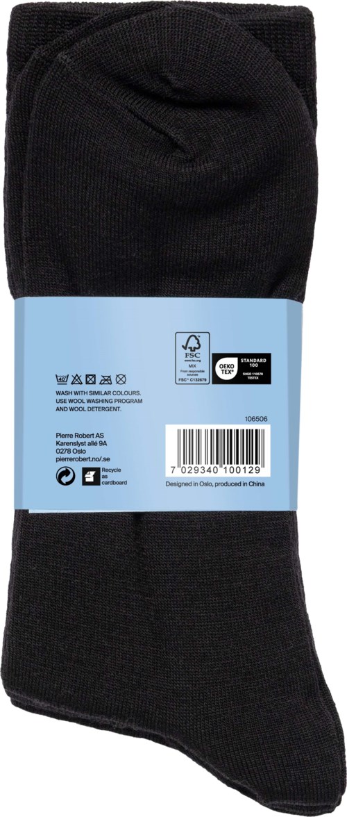 A black sock with a blue label around it, showing washing instructions and bar code.