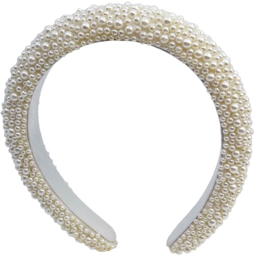 A white headband decorated with small, shiny pearls all around it.