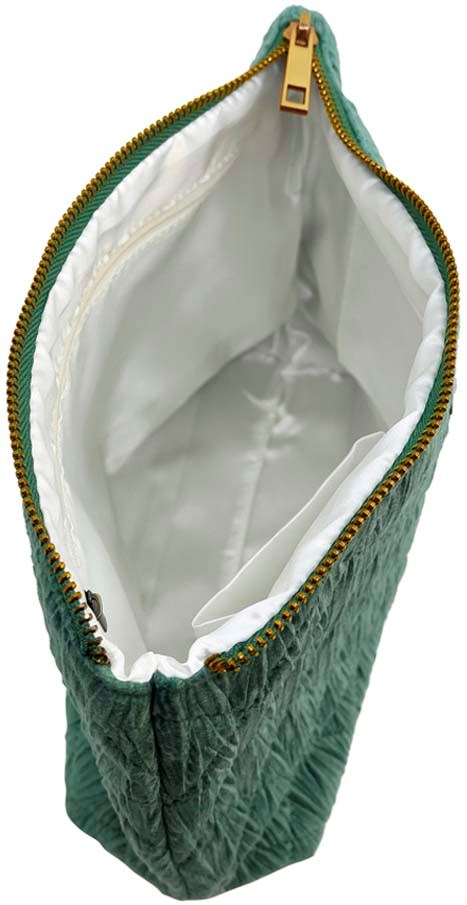 A green bag with quilted fabric and a gold zipper, open to show a white interior with space for items.