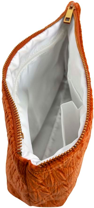 Orange quilted bag with zipper, white interior, and multiple slots inside.
