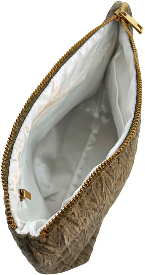 A small quilted bag with a zipper, inside is light-colored fabric, empty.