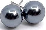 Two shiny metal balls sit close together, reflecting their surroundings with a silver color.