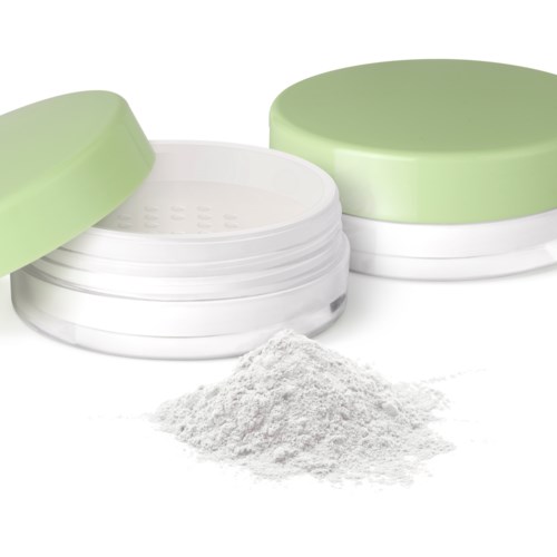 A round white container with a light green lid, open with powder spilling out nearby.