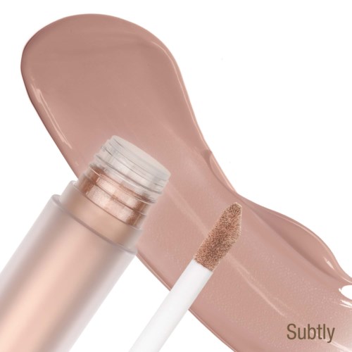 En flaske foundation med en prøve af beige makeup ved siden af.