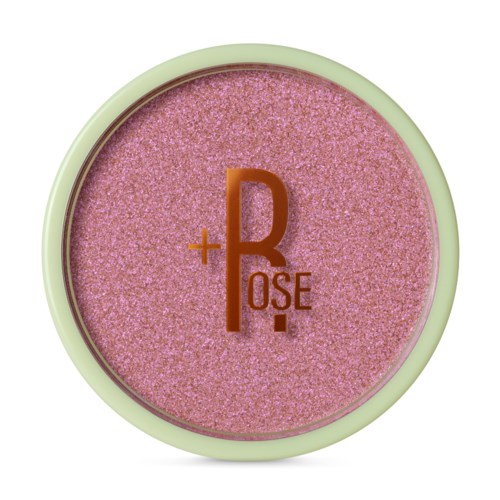 Pink makeupprodukt med texten '+R+OSE' på sig. Rund med en ljusgrön kant.