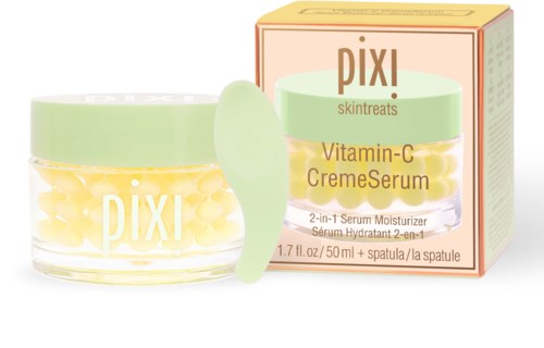 En burk med gula kapslar och en liten spatel med en box med Vitamin-C serum från Pixi.