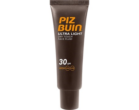 En brun tub med orange och vitt text, visar en ansiktsolja med solskyddsfaktor 30, lätt och för torr hud.