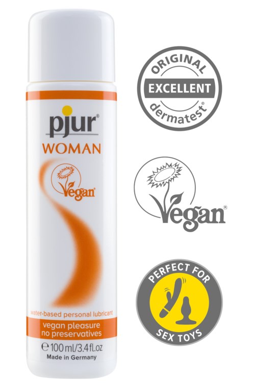 A white spray bottle with orange details labeled 'pjur WOMAN', with logos for vegan, skin-friendly, and sex toy compatibility.