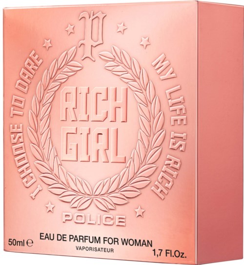 Pink perfume box features the phrase 'Rich Girl' inside a laurel wreath with stars, police badge, and slogans about enjoying life.