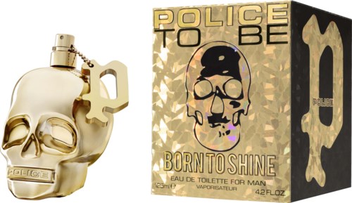 En gullfarget duftflaske i form av en hodeskalle og en eske med skalle- og politiavbildninger, merket 'Born to Shine.'