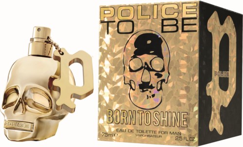 A perfume bottle shaped like a skull with a key chain, and a box with skull art and the words "Born to Shine."