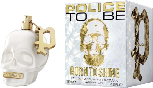 A skull-shaped perfume bottle with a key charm and a box labeled "POLICE TO BE BORN TO SHINE."