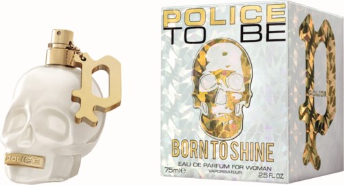 A perfume bottle shaped like a skull with a gold keychain, and a box with a skull and leopard print design.