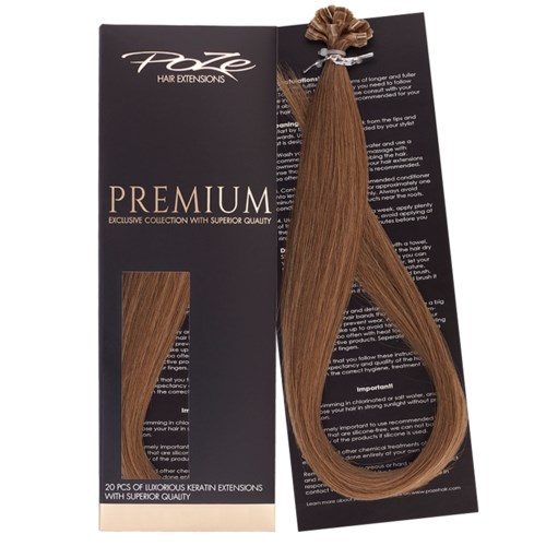 A set of brown hair extensions in a black package with white and beige text, and a hair extension attached.