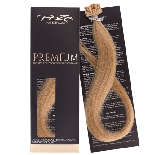 Blonde hair extensions in a black packaging with gold and white text. The extensions are long, smooth, and shiny.