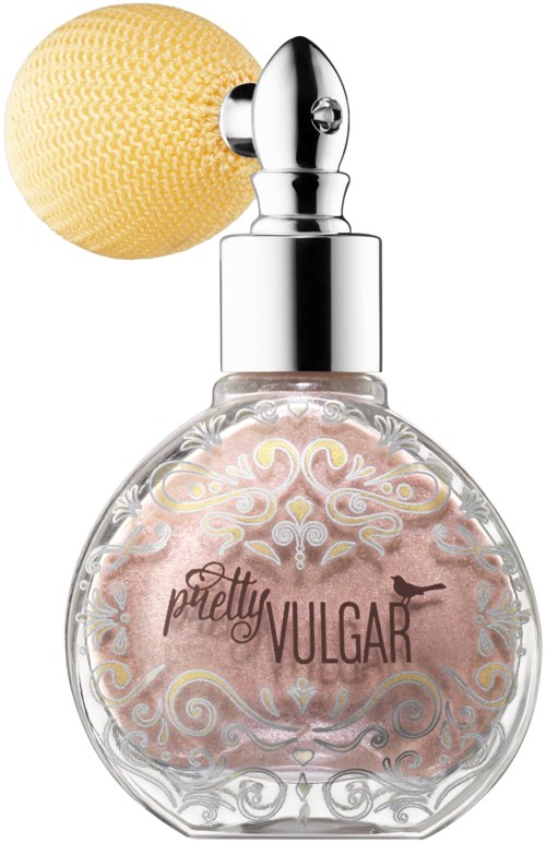 A perfume bottle with a decorative clear design, pink liquid inside, and a yellow sponge on top.