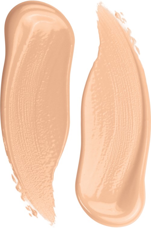 Två smörjstreck av beige eller ljus persika flytande makeup eller foundation på vit bakgrund.