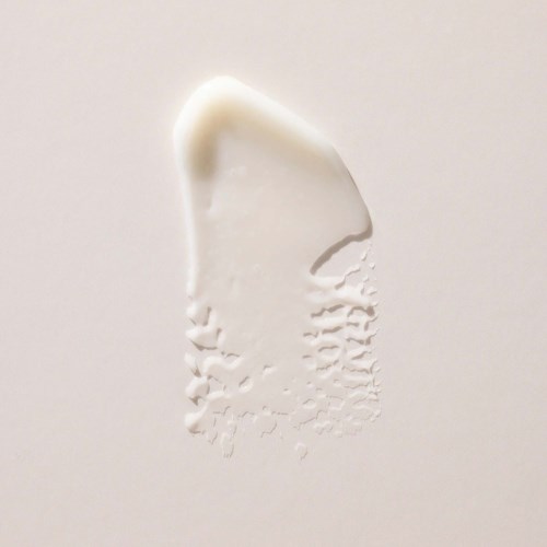 White plaster with a curved shape and textured bottom, on a plain background.