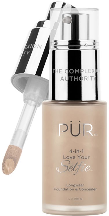 En beige foundationsflaske med en sølvpumpe og gennemsigtigt låg, mærket 'PUR 4-in-1 Love Your Selfie Longwear Foundation & Concealer.'