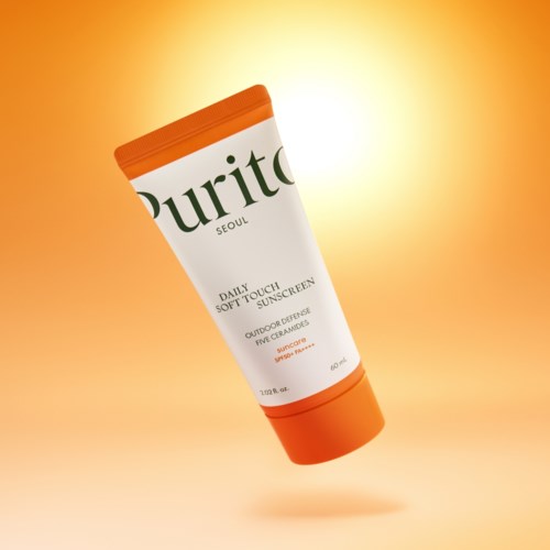 Purito solskyddsprodukt i tub, i orange och vitt, för daglig skydd utomhus.