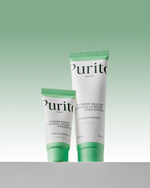 To tuber av Purito Wonder Releaf Centella Cream, en stor og en liten, mot en grønn og hvit bakgrunn.