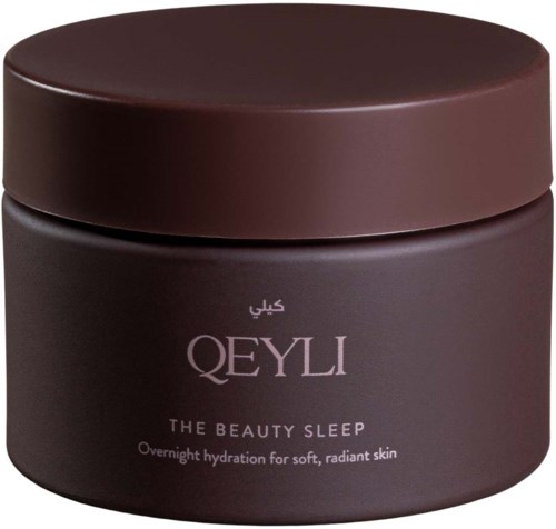 Mörkbrun förpackning av QEYLI The Beauty Sleep ansiktskräm med vitt text, som anger att den är en nattligt återfuktande kräm.