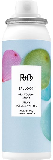 A can of dry volume spray with colorful balloons on the label.
