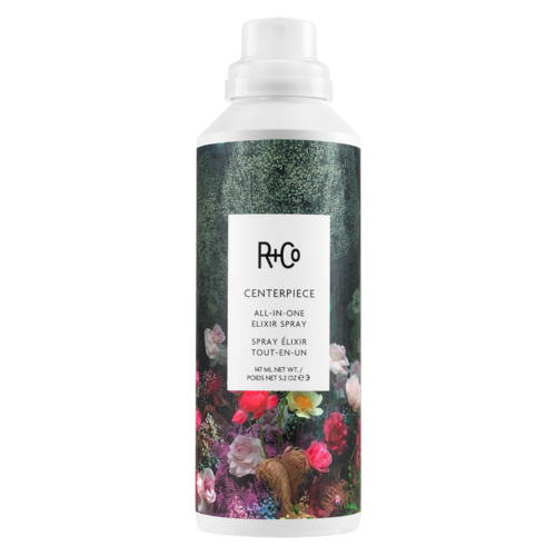 Biała butelka z kwiatowym wzorem, oznaczona R+Co Centerpiece All-in-One Elixir Spray.