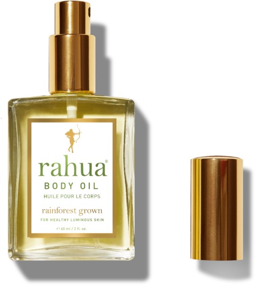 En klar glassflaske med Rahua kroppsolje med gull pumpe og lokk, merket "rainforest grown" for sunn hud.