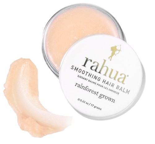 En liten krukke med Rahua-glattende hårbalsam med en beigefarget balsam og en separat del av produktet utenfor.