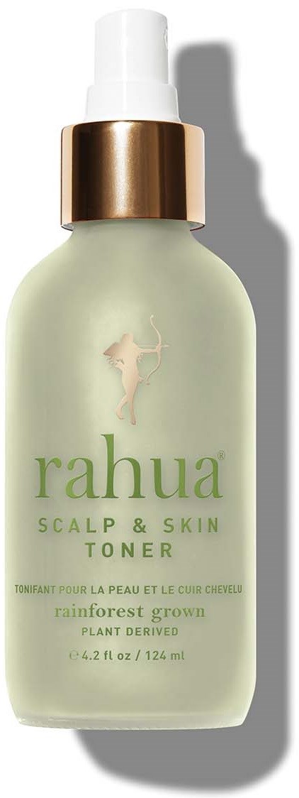 A light green bottle of Rahua scalp and skin toner with a white and gold cap, labeled for rainforest-grown, plant-derived ingredients.