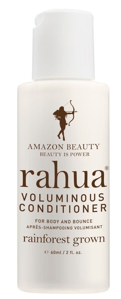 En hvit flaske med Rahua voluminerende balsam med lokk, merket for ingredienser fra regnskogen, for kropp og volumn.