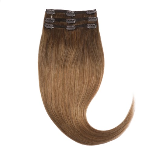 A hair extension with light brown, straight hair attached to clips. It looks smooth and shiny.