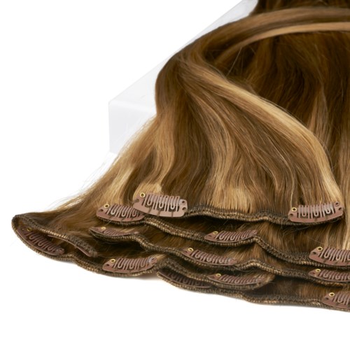 The image shows a hair extension product with multiple brown wefts laid out on a white surface.
