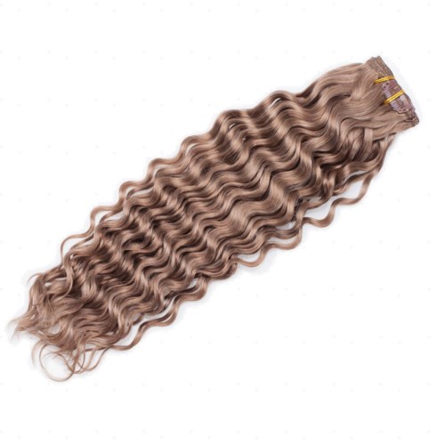 A long, curly, blonde hair extension or wig clipped at the top, with loose waves and shiny texture.