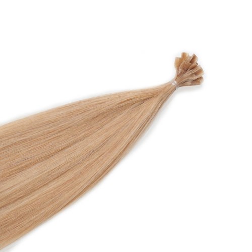 En bunt blont hårförlängningar knutits i ena änden, utbredda i andra.